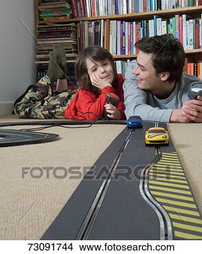 Stock Photo - boy (5-7) racing 
toy cars with 
man. fotosearch 
- search stock 
photos, pictures, 
images, and photo 
clipart