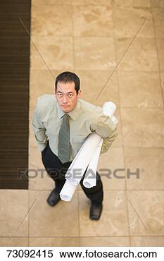 Stock Image - businessman holding 
drafts, elevated 
view. fotosearch 
- search stock 
photos, pictures, 
images, and photo 
clipart