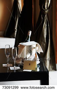Stock Photograph - champagne glasses 
beside bottle 
in ice bucket 
on table. fotosearch 
- search stock 
photos, pictures, 
images, and photo 
clipart