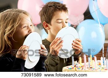 Stock Photograph - children (5-10 
years) licking 
plates at birthday 
party. fotosearch 
- search stock 
photos, pictures, 
images, and photo 
clipart