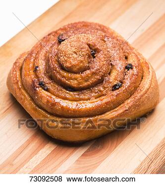 Stock Photo - cinnamon roll 
on wood grain 
surface, close-up. 
fotosearch - search 
stock photos, 
pictures, images, 
and photo clipart