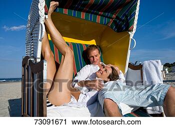 Stock Photography - couple relaxing 
in beach shelter. 
fotosearch - search 
stock photos, 
pictures, images, 
and photo clipart
