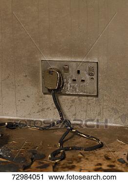 Stock Photography - dirty electric 
plug with frayed 
cable in dirty 
wall outlet. fotosearch 
- search stock 
photos, pictures, 
images, and photo 
clipart