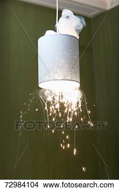 Stock Photo - domestic light 
bulb in lampshade 
exploding. fotosearch 
- search stock 
photos, pictures, 
images, and photo 
clipart