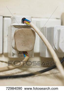 Stock Photography - electric plugs 
with exposed cables 
in wall outlet, 
close-up. fotosearch 
- search stock 
photos, pictures, 
images, and photo 
clipart