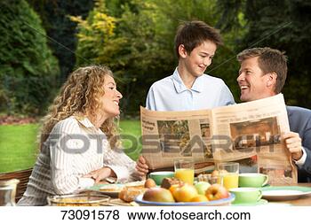 Stock Photo - father with newspaper 
laughing with 
son (10-11 years), 
 mother. fotosearch 
- search stock 
photos, pictures, 
images, and photo 
clipart