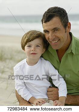 Stock Photo - father and son 
(3-4) on beach, 
portrait. fotosearch 
- search stock 
photos, pictures, 
images, and photo 
clipart