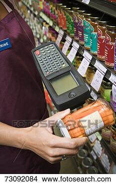 Stock Photo - female shop assistant 
checking product 
barcode, close-up 
on hand. fotosearch 
- search stock 
photos, pictures, 
images, and photo 
clipart