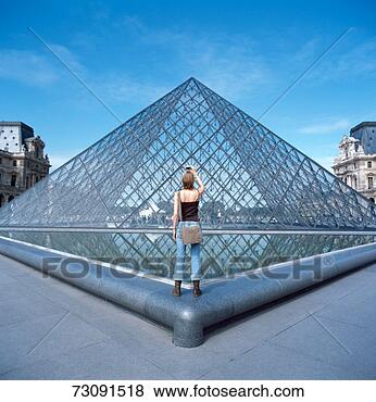 Stock Photo - france, paris, 
louvre, young 
woman taking photograph, 
rear view. fotosearch 
- search stock 
photos, pictures, 
images, and photo 
clipart