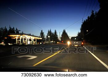 Stock Photography - gas station and 
traffic on country 
road at dusk (blurred 
motion). fotosearch 
- search stock 
photos, pictures, 
images, and photo 
clipart