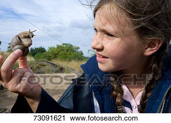 Stock Photography - girl (8-9) holding 
snail outdoorsclose-up. 
fotosearch - search 
stock photos, 
pictures, images, 
and photo clipart