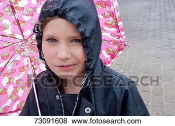 Stock Photo - girl (8-9) wearing 
hooded raincoat 
under umbrella 
in rain. fotosearch 
- search stock 
photos, pictures, 
images, and photo 
clipart