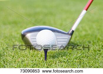 Stock Photo - golf club behind 
golf ball on tee, 
close-up. fotosearch 
- search stock 
photos, pictures, 
images, and photo 
clipart