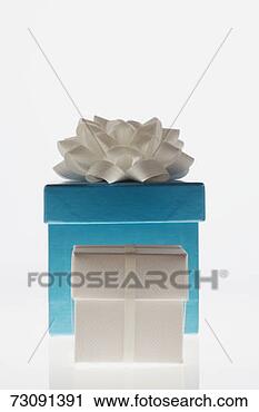 Stock Photography - large blue gift 
box behind small 
white gift box. 
fotosearch - search 
stock photos, 
pictures, images, 
and photo clipart