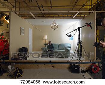 Stock Photo - living room set 
in photographic 
studio,  mature 
man on sofa drinking. 
fotosearch - search 
stock photos, 
pictures, images, 
and photo clipart