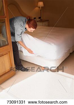 Stock Photography - maid preparing 
bed in hotel room. 
fotosearch - search 
stock photos, 
pictures, images, 
and photo clipart