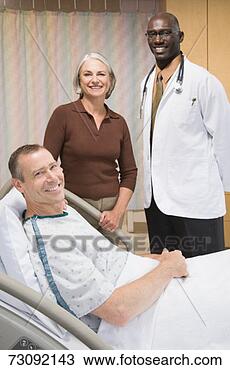 Stock Photo - male doctor and 
female visitor 
standing beside 
male patient lying 
in. fotosearch 
- search stock 
photos, pictures, 
images, and photo 
clipart