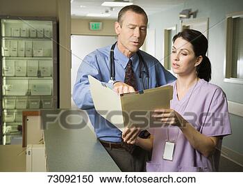 Stock Photography - male doctor and 
female nurse discussing 
medical file. 
fotosearch - search 
stock photos, 
pictures, images, 
and photo clipart