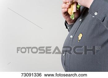 Stock Photo - man eating sandwich 
spilling sauce 
on shirt, mid 
section. fotosearch 
- search stock 
photos, pictures, 
images, and photo 
clipart