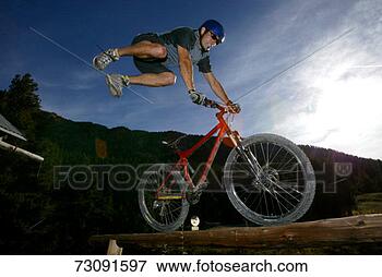 Picture - man on mountain 
bike doing mid-air 
stunt. fotosearch 
- search stock 
photos, pictures, 
images, and photo 
clipart