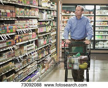 Stock Photo - man pushing shopping 
trolley in store 
aisle. fotosearch 
- search stock 
photos, pictures, 
images, and photo 
clipart