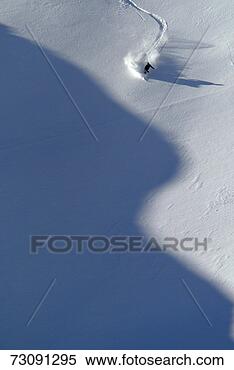 Stock Image - man telemarking 
down mountain 
slope. fotosearch 
- search stock 
photos, pictures, 
images, and photo 
clipart