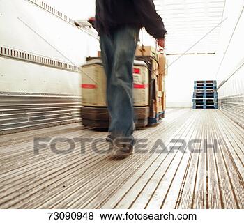 Stock Photo - man unloading 
truck trailer, 
low section (blurred 
motion). fotosearch 
- search stock 
photos, pictures, 
images, and photo 
clipart