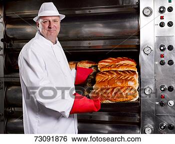 Stock Photo - master baker presenting 
tray of fresh 
breads in bakery, 
portrait. fotosearch 
- search stock 
photos, pictures, 
images, and photo 
clipart