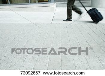 Picture - mature business 
man walking with 
suitcase, low 
section. fotosearch 
- search stock 
photos, pictures, 
images, and photo 
clipart