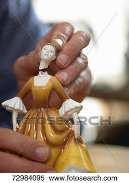 Stock Image - mature man repairing 
head of broken 
china figurine, 
close-up. fotosearch 
- search stock 
photos, pictures, 
images, and photo 
clipart