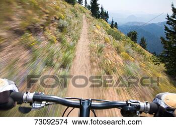 Stock Photo - mature man riding 
bike down dirt 
path (blurred 
motion). fotosearch 
- search stock 
photos, pictures, 
images, and photo 
clipart