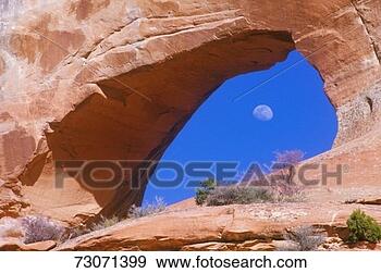 Stock Photograph - 'moon seen through 
rock formation, 
utah'. fotosearch 
- search stock 
photos, pictures, 
images, and photo 
clipart