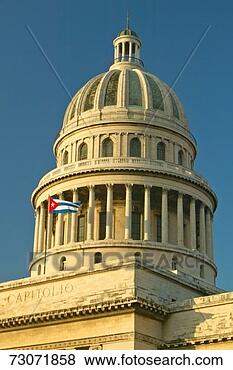 Stock Photo - 'morning light 
on the capitolio 
and cuban flag, 
 the cuban capitol. 
fotosearch - search 
stock photos, 
pictures, images, 
and photo clipart