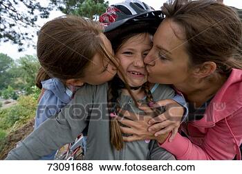 Stock Photo - mother and daughter 
(10-11) kissing 
girl (8-9) wearing 
sports. fotosearch 
- search stock 
photos, pictures, 
images, and photo 
clipart