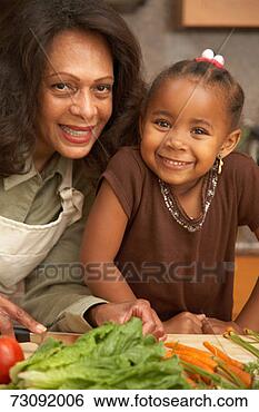 Stock Photo - mother and daughter 
(3-5) in kitchen, 
 smiling,  chopping 
vegetables. fotosearch 
- search stock 
photos, pictures, 
images, and photo 
clipart