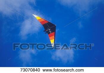 Stock Photography - 'multi-colored 
hang glider in 
mid-air,  hang 
gliding festival. 
fotosearch - search 
stock photos, 
pictures, images, 
and photo clipart