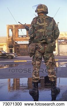 Stock Photography - 'national guardsman 
standing in front 
of burned business 
after 1992. fotosearch 
- search stock 
photos, pictures, 
images, and photo 
clipart