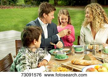 Stock Photo - parents and children 
(5-10 years) having 
meal outside. 
fotosearch - search 
stock photos, 
pictures, images, 
and photo clipart