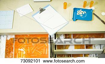 Stock Photography - pharmacist's counter, 
 clip board,  
medication,  drawers 
open. fotosearch 
- search stock 
photos, pictures, 
images, and photo 
clipart