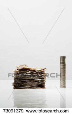 Stock Photograph - pile of banknotes 
and stack of coins. 
fotosearch - search 
stock photos, 
pictures, images, 
and photo clipart
