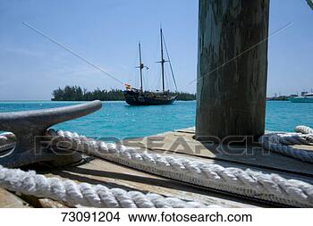 Stock Photo - sailboat at anchor, 
ropes in foreground, 
low angle view. 
fotosearch - search 
stock photos, 
pictures, images, 
and photo clipart