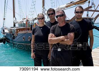 Stock Photo - sailboat captain 
and crew standing 
wearing sunglasses 
on jetty. fotosearch 
- search stock 
photos, pictures, 
images, and photo 
clipart