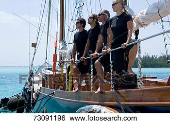 Stock Photo - sailboat captain 
and crew standing 
in a row wearing 
sunglasses on. 
fotosearch - search 
stock photos, 
pictures, images, 
and photo clipart