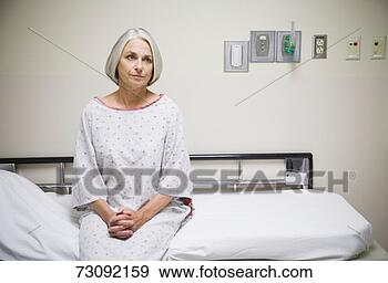 Stock Photograph - senior female 
patient sitting 
on examination 
table, portrait. 
fotosearch - search 
stock photos, 
pictures, images, 
and photo clipart