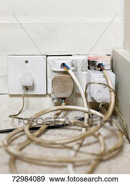 Stock Photograph - several electric 
plugs with dirty 
and worn cables 
in wall outlet. 
fotosearch - search 
stock photos, 
pictures, images, 
and photo clipart