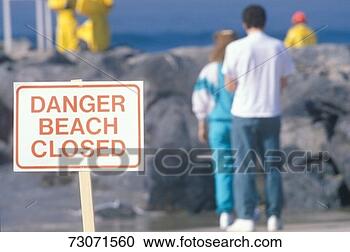 Stock Photography - 'a sign warning, 
danger beach closed 
with people in 
the background'. 
fotosearch - search 
stock photos, 
pictures, images, 
and photo clipart
