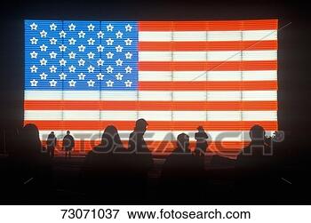 Picture - 'silhouettes of 
people in front 
of an american 
electric flag, 
 winter. fotosearch 
- search stock 
photos, pictures, 
images, and photo 
clipart