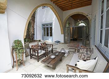 Stock Photo - sofa, arm chairs, 
coffee table on 
terrace of mediterranean 
style house. fotosearch 
- search stock 
photos, pictures, 
images, and photo 
clipart