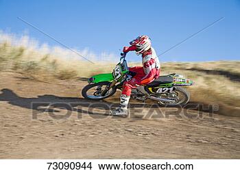 Stock Photo - teenage boy (14-15) 
riding motocross 
motorcycle on 
dirt track. fotosearch 
- search stock 
photos, pictures, 
images, and photo 
clipart