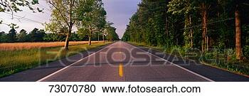Stock Photography - this is a tree 
lined road at 
sunset it is located 
on the eastern. 
fotosearch - search 
stock photos, 
pictures, images, 
and photo clipart